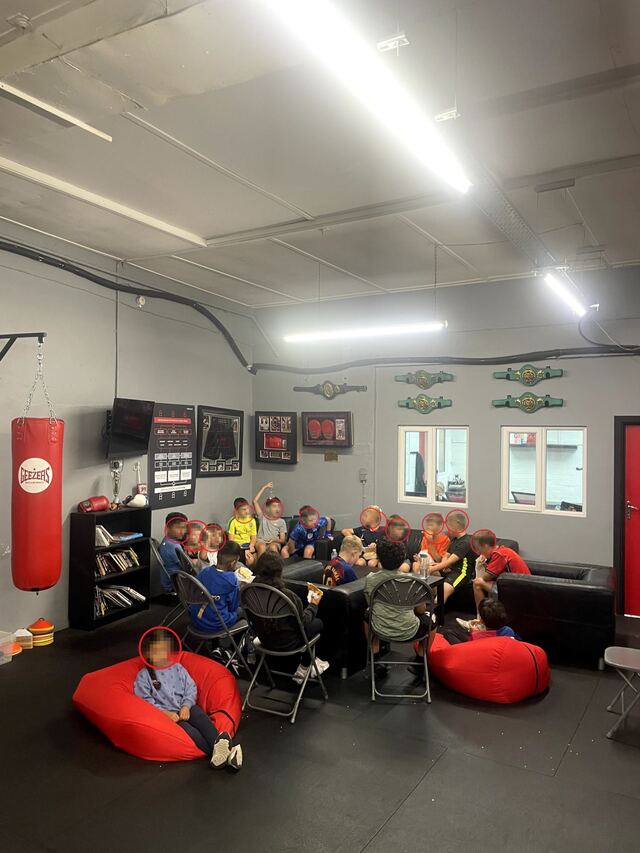 Primary-age students sitting together in the Training Cave learning space